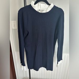 Lacy neck accents and sleeves level ups this navy sweater.